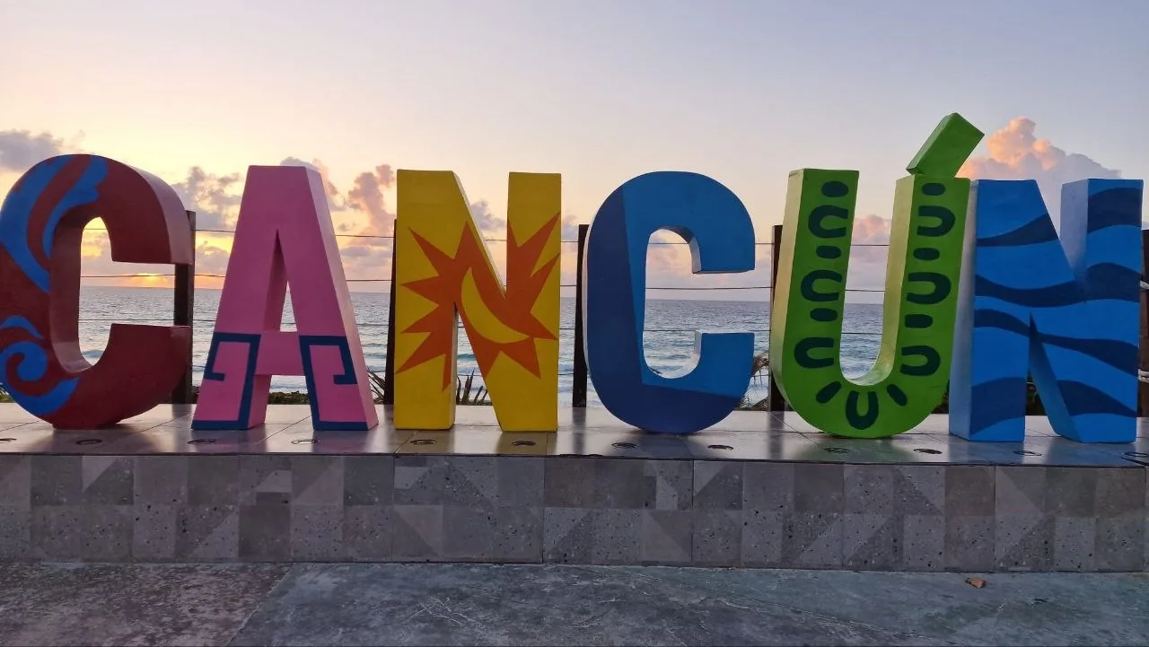 Enseigne de Cancún devant la mer pour un voyage au soleil au Mexique